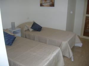 Bedroom 2 with fitted wardrobes and access to second balcony